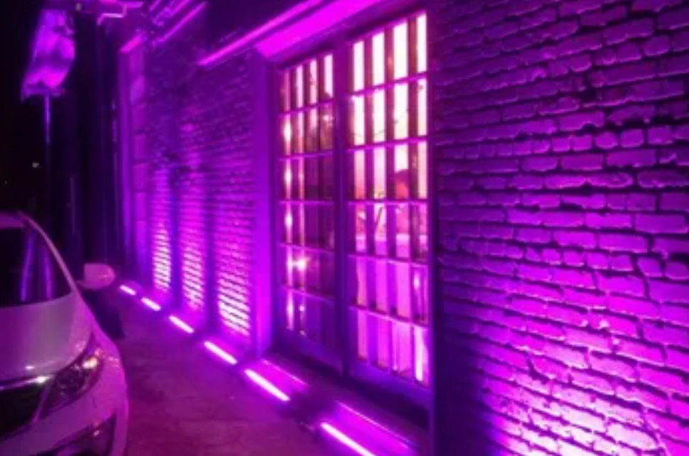 Amber accent lighting along a waterfront promenade